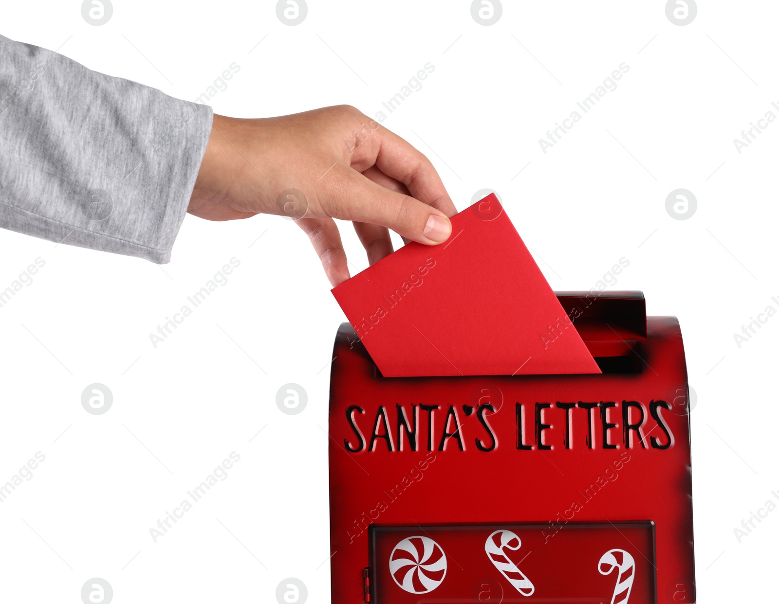 Photo of Man putting letter to Santa Claus into red mail box against white background, closeup. Christmas tradition