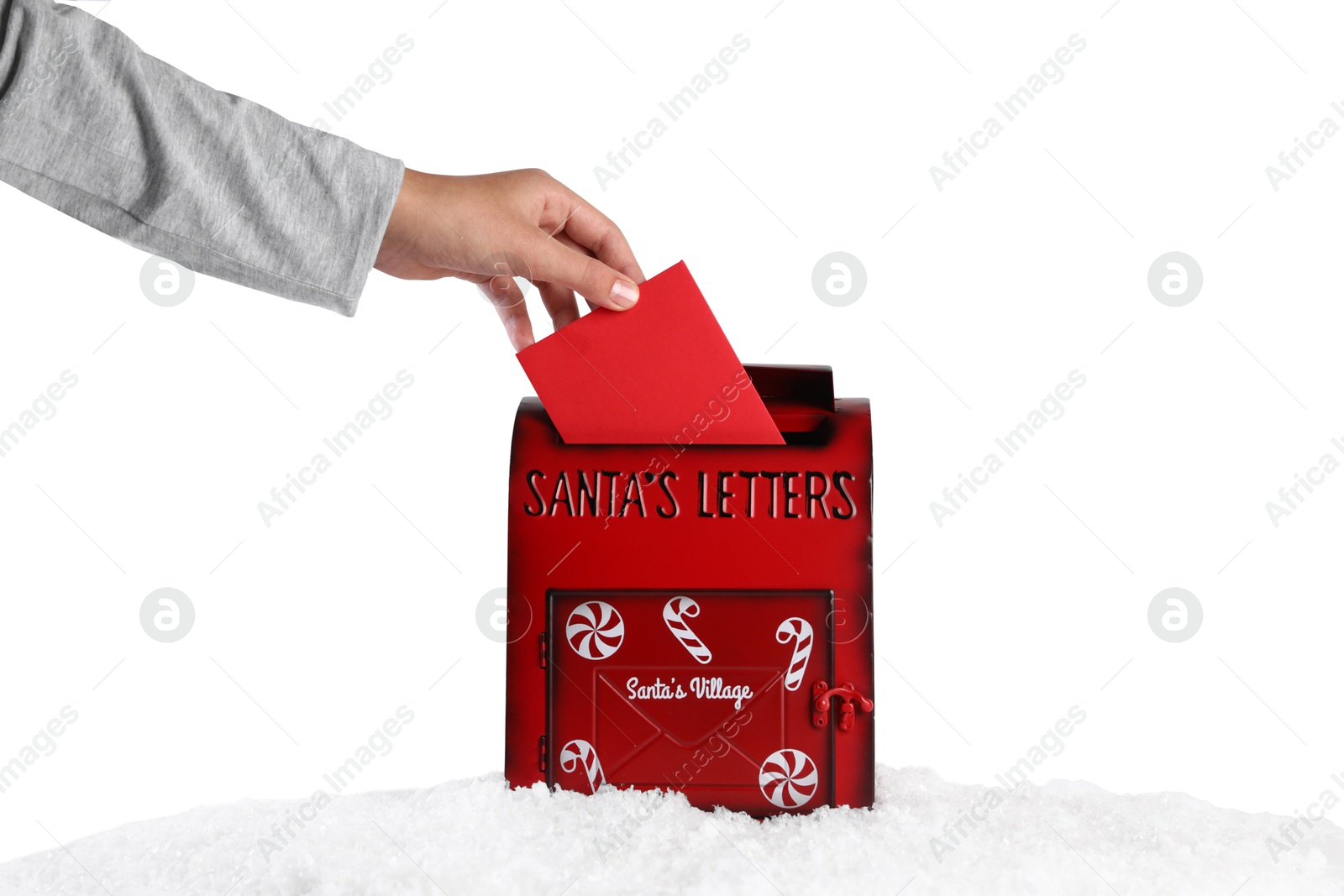 Photo of Man putting letter to Santa Claus into red mail box against white background, closeup. Christmas tradition