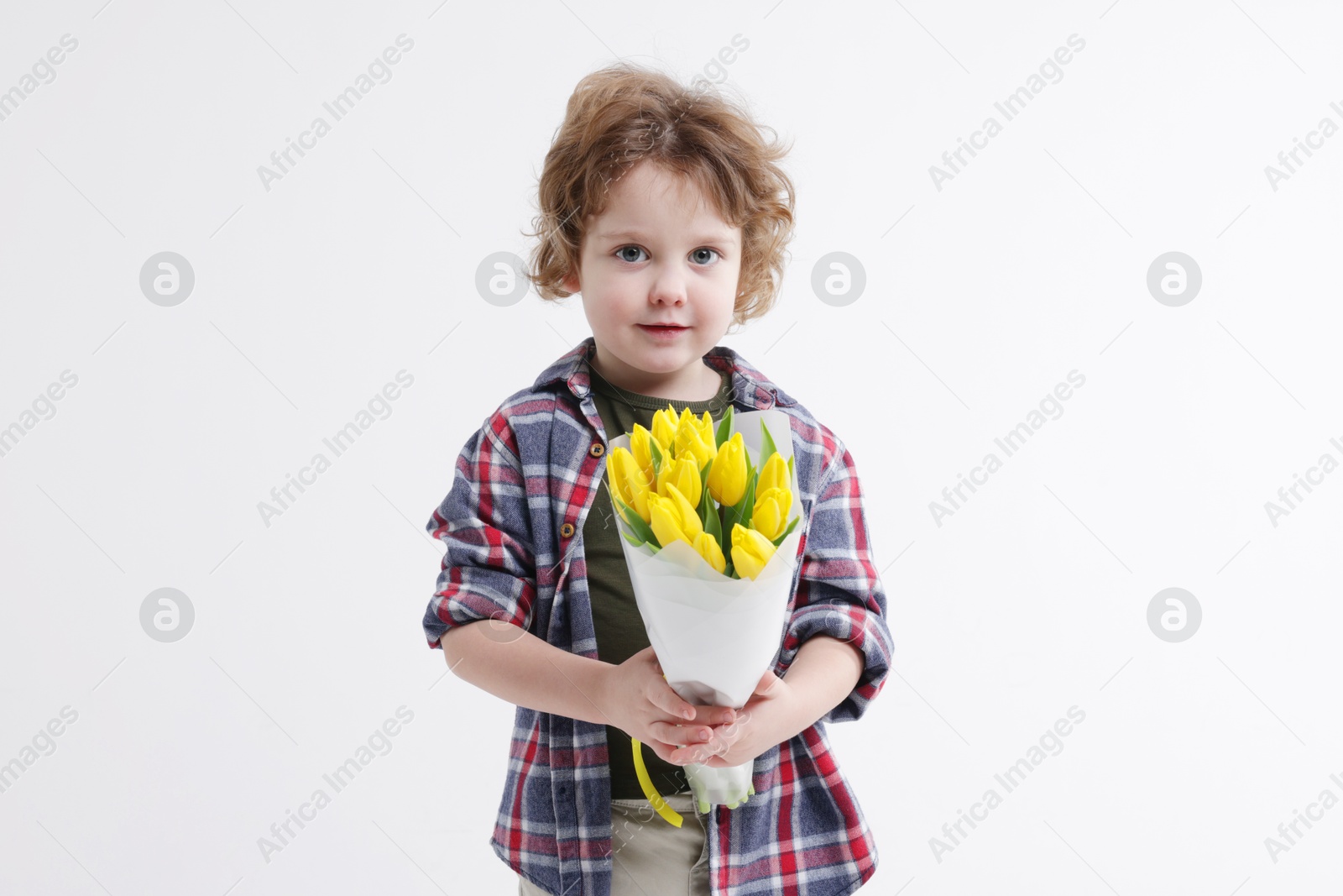 Photo of Cute little boy with bouquet of tulips on white background