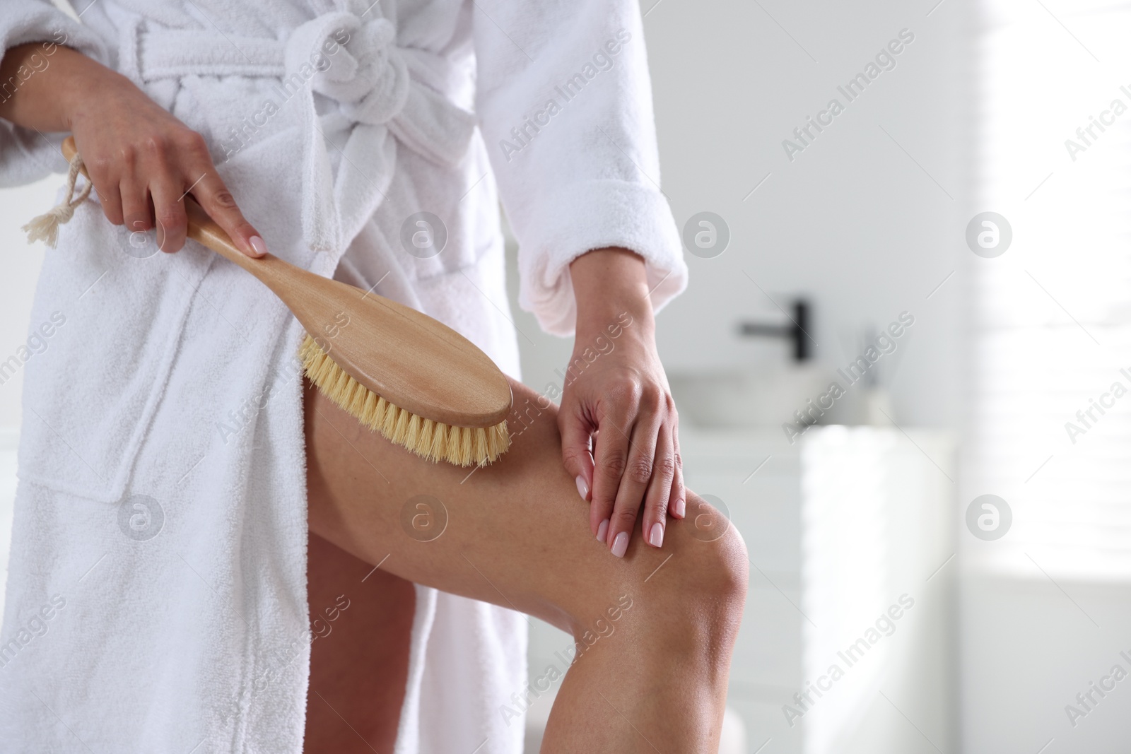 Photo of Woman doing anti cellulite massage with brush indoors, closeup. Space for text