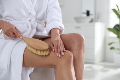 Photo of Woman doing anti cellulite massage with brush indoors, closeup. Space for text