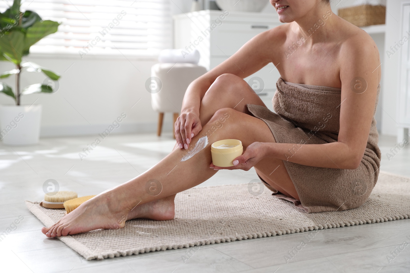 Photo of Woman applying anti cellulite cream indoors, closeup. Space for text