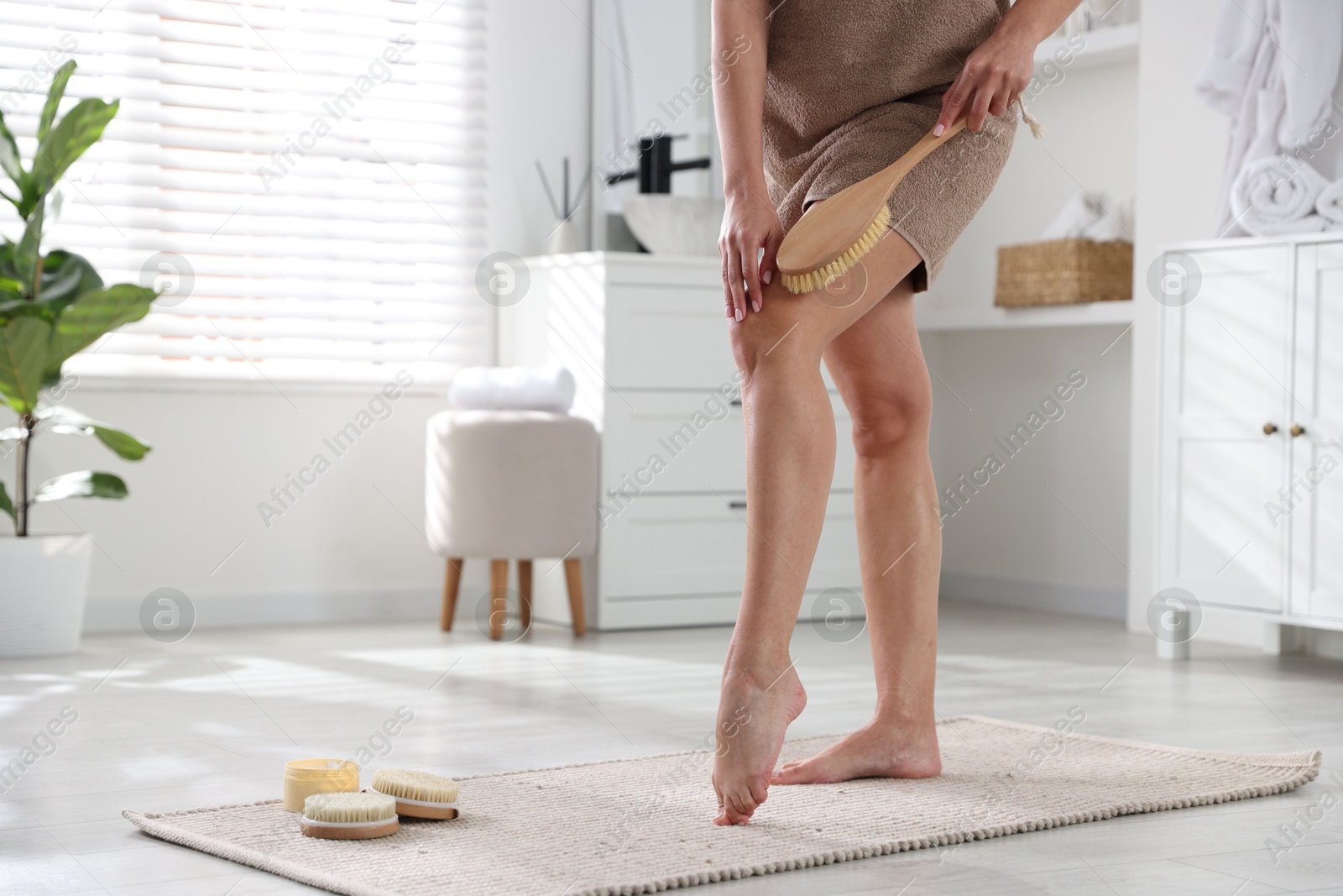 Photo of Woman doing anti cellulite massage with brush indoors, closeup. Space for text