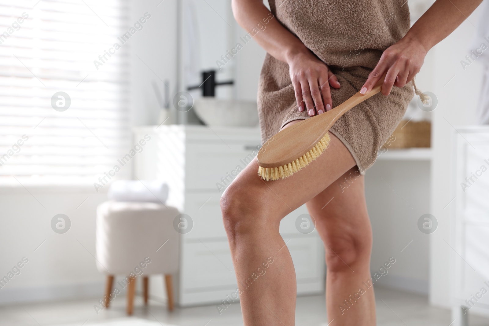 Photo of Woman doing anti cellulite massage with brush indoors, closeup. Space for text