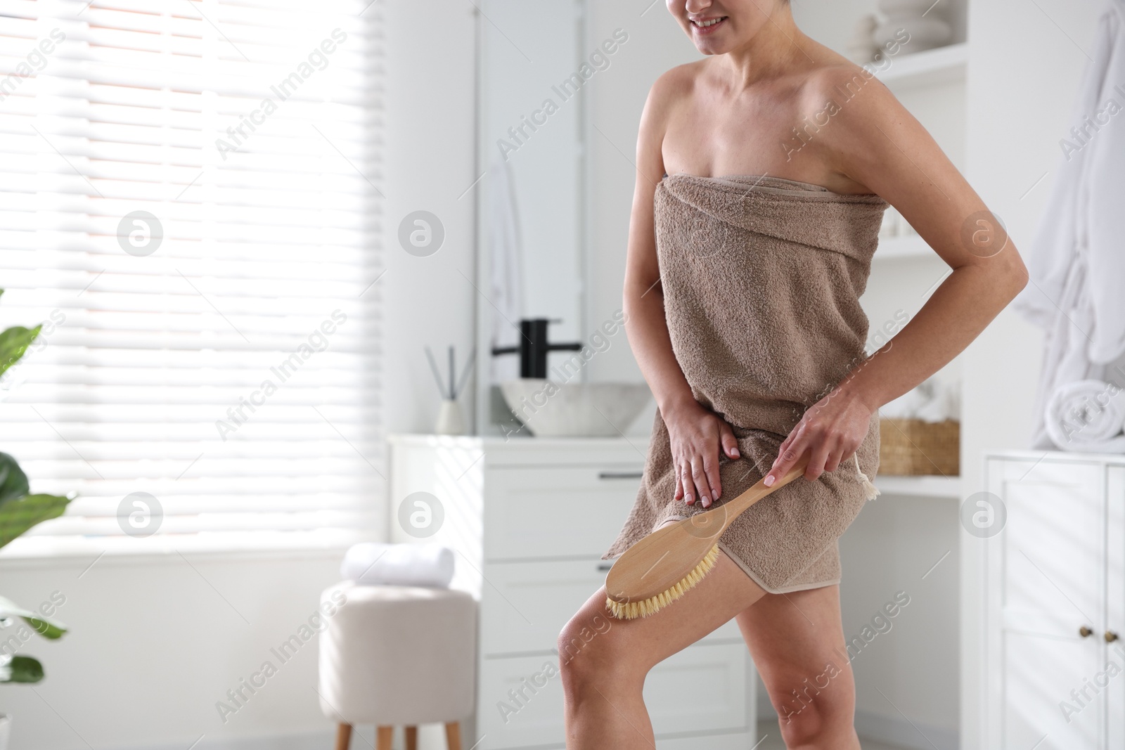 Photo of Woman doing anti cellulite massage with brush indoors, closeup. Space for text