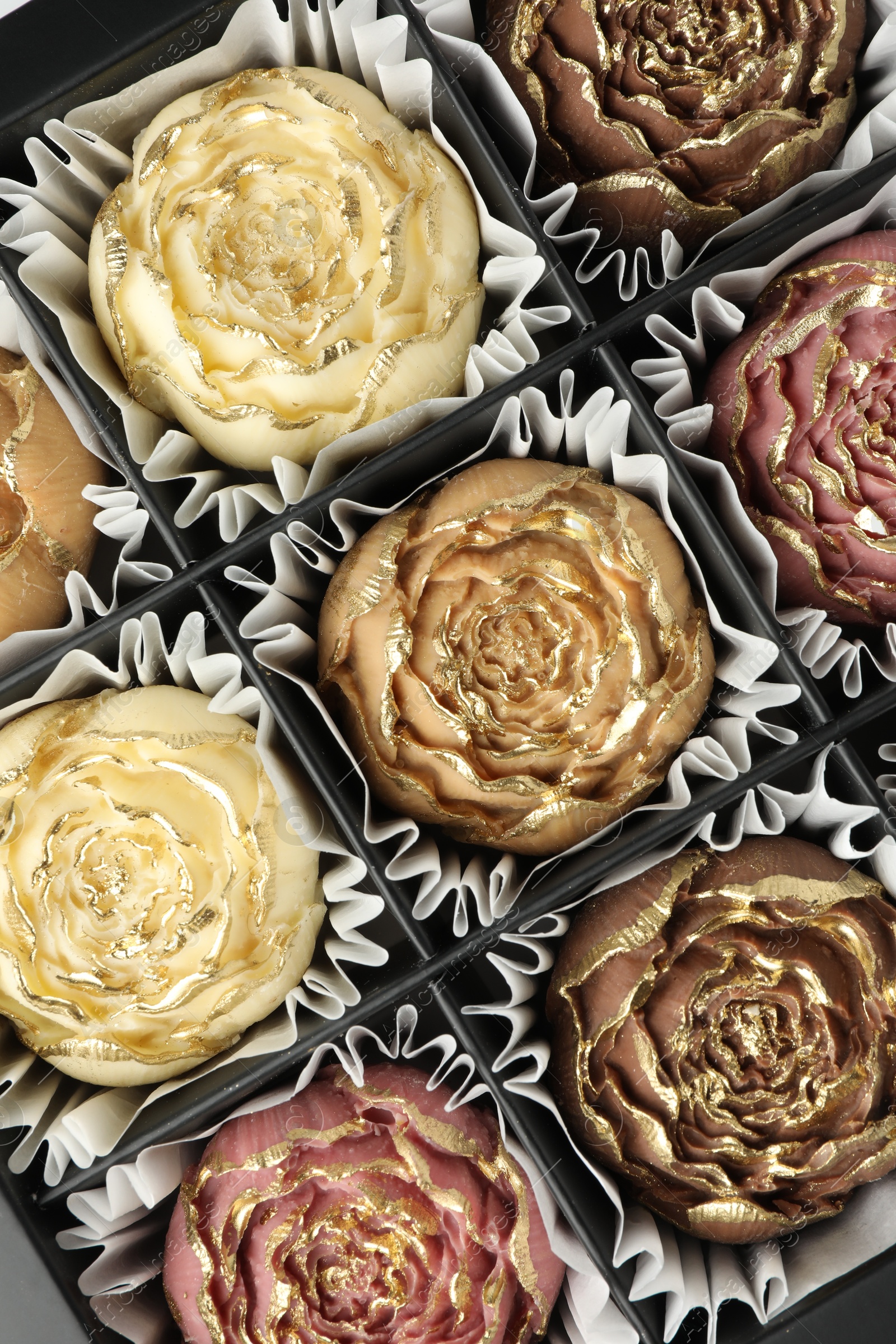 Photo of Flower shaped chocolate bonbons in box, top view