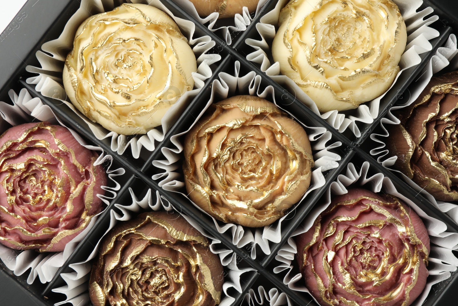 Photo of Flower shaped chocolate bonbons in box, top view