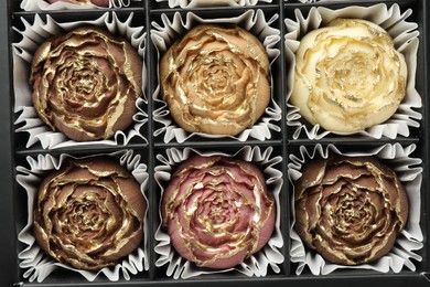 Photo of Flower shaped chocolate bonbons in box, top view