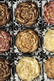 Photo of Flower shaped chocolate bonbons in box, top view