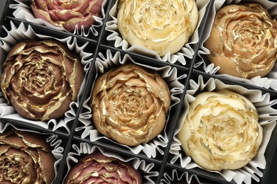 Photo of Flower shaped chocolate bonbons in box, top view