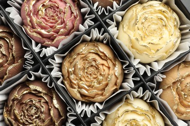 Photo of Flower shaped chocolate bonbons in box, top view