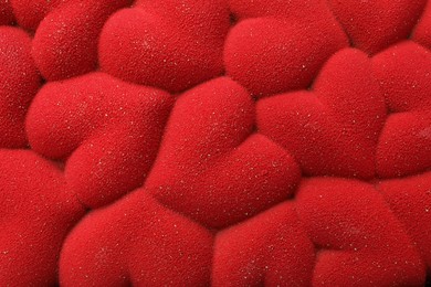 Photo of Chocolate bar decorated with hearts as background, top view