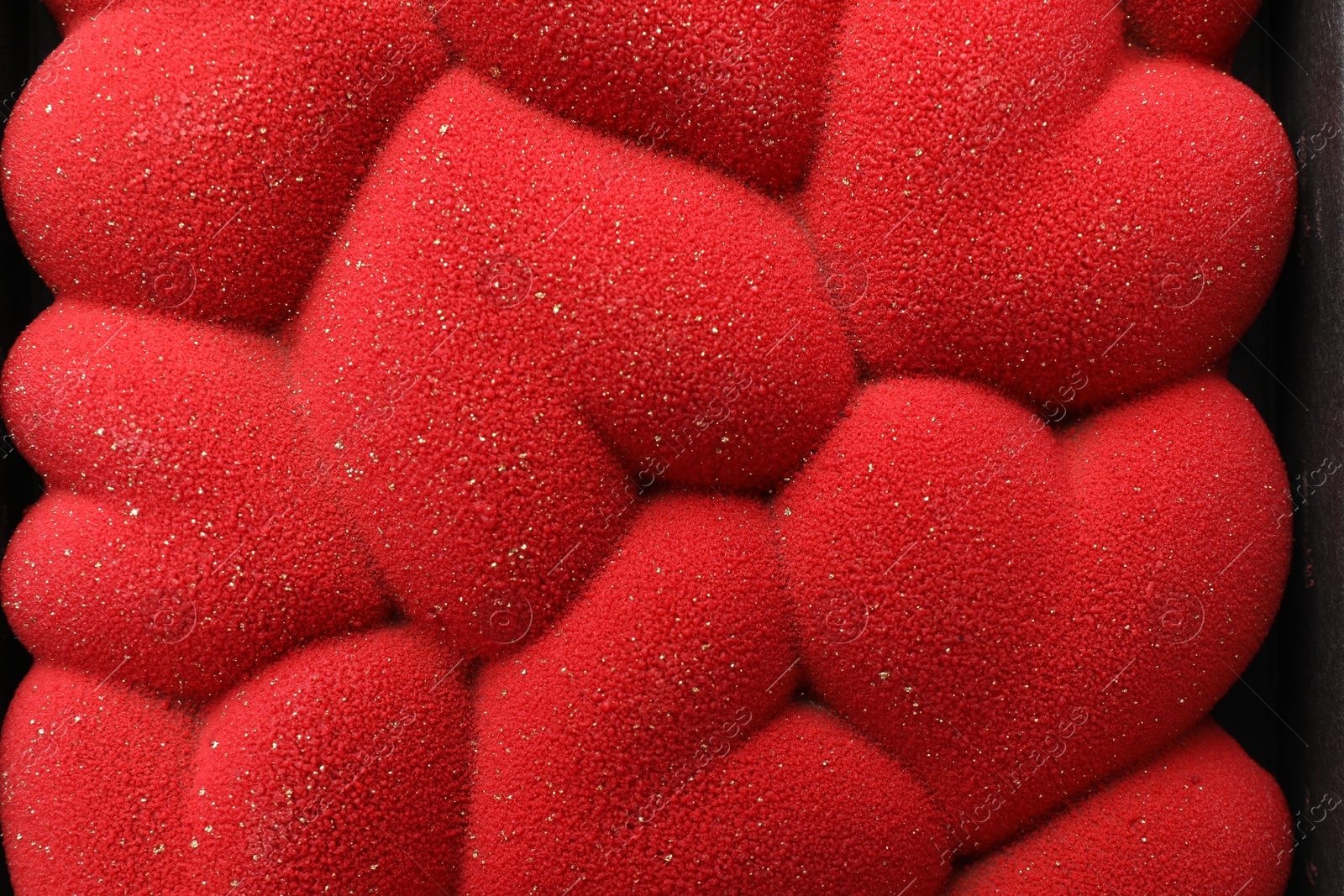 Photo of Chocolate bar decorated with hearts in box, top view