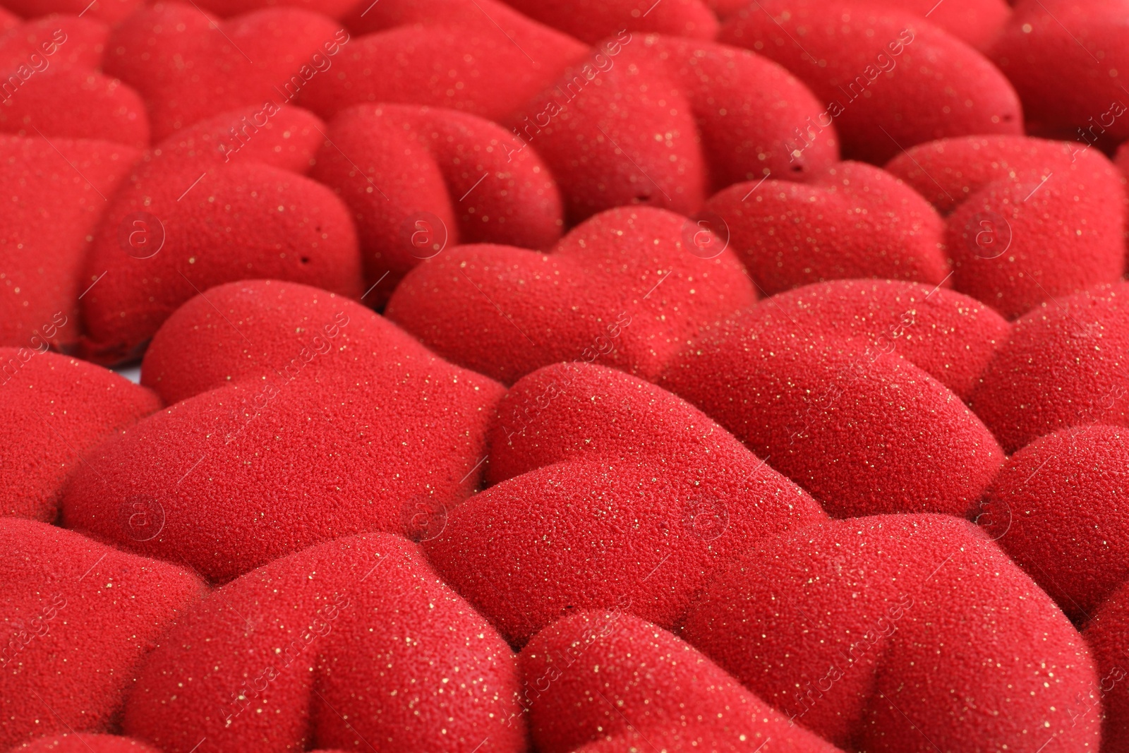 Photo of Chocolate bar decorated with hearts as background, closeup