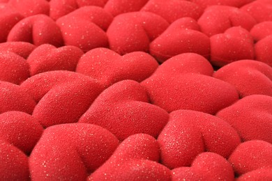 Photo of Chocolate bar decorated with hearts as background, closeup