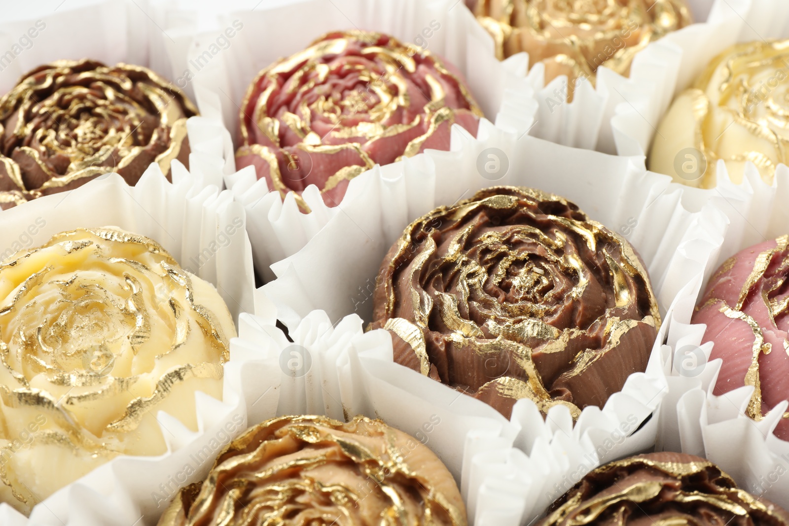 Photo of Flower shaped chocolate bonbons as background, closeup