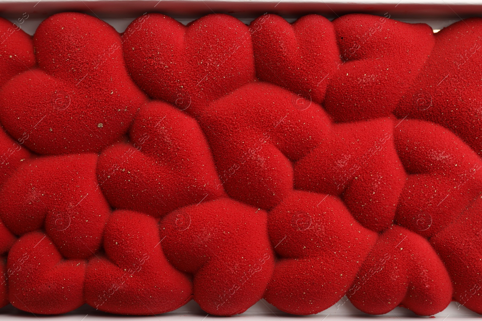 Photo of Chocolate bar decorated with hearts in box, top view