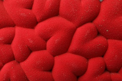 Photo of Chocolate bar decorated with hearts as background, top view