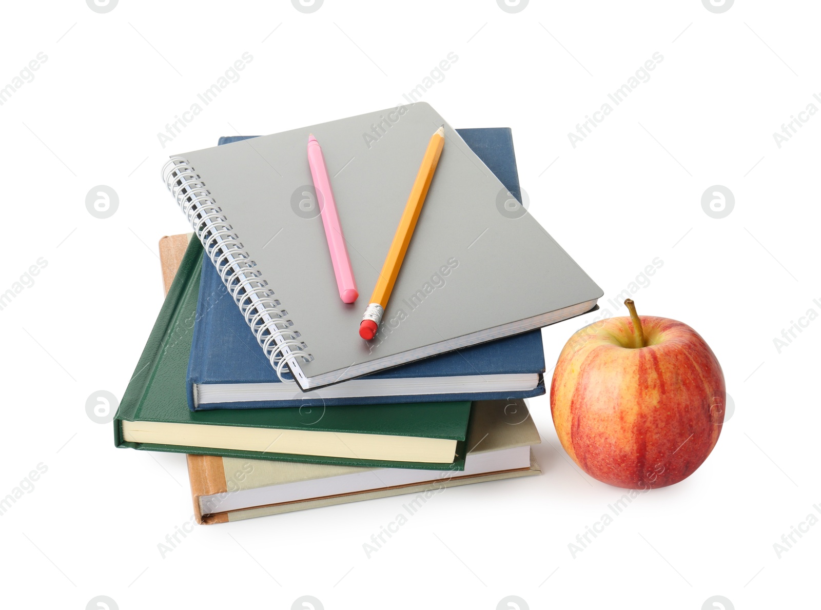 Photo of Stack of notebooks, pen, pencil and apple on white background