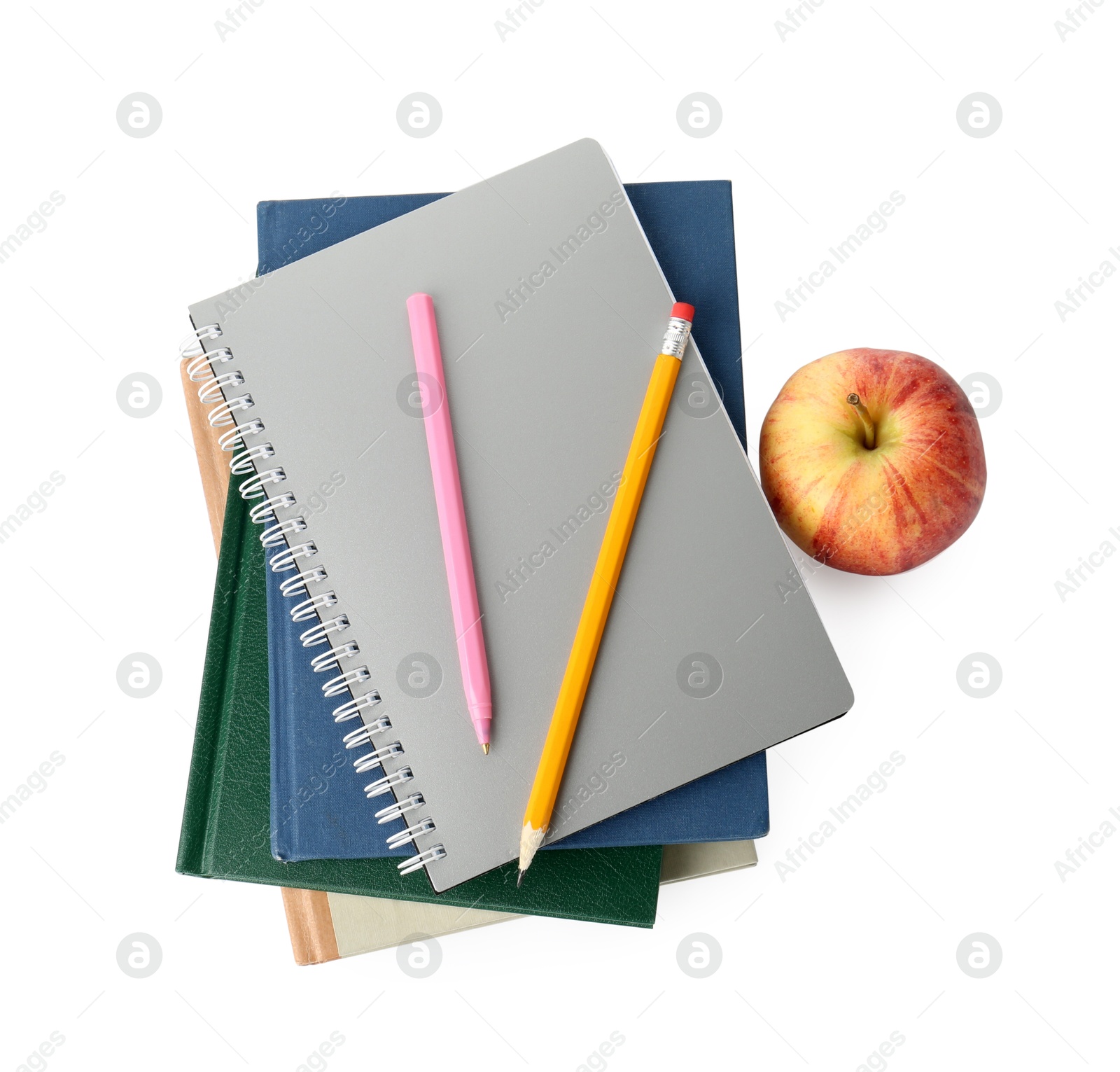 Photo of Stack of notebooks, pen, pencil and apple isolated on white, top view