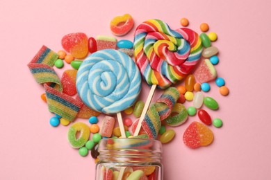 Photo of Many different tasty candies on pink background, flat lay