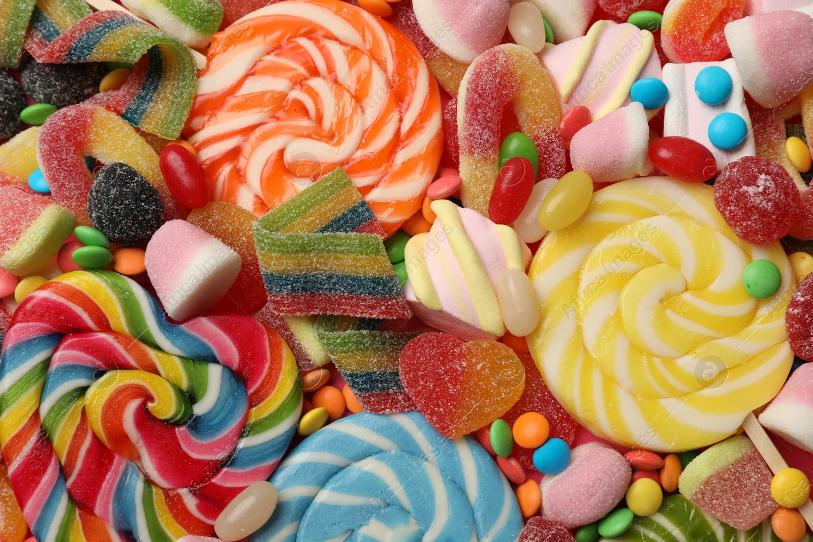 Photo of Different tasty candies as background, top view