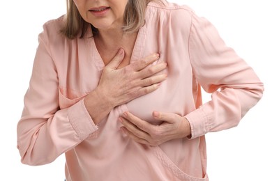 Heart attack. Senior woman suffering from pain in chest on white background, closeup