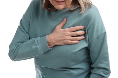 Photo of Heart attack. Senior woman suffering from pain in chest on white background, closeup