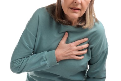 Photo of Heart attack. Senior woman suffering from pain in chest on white background, closeup