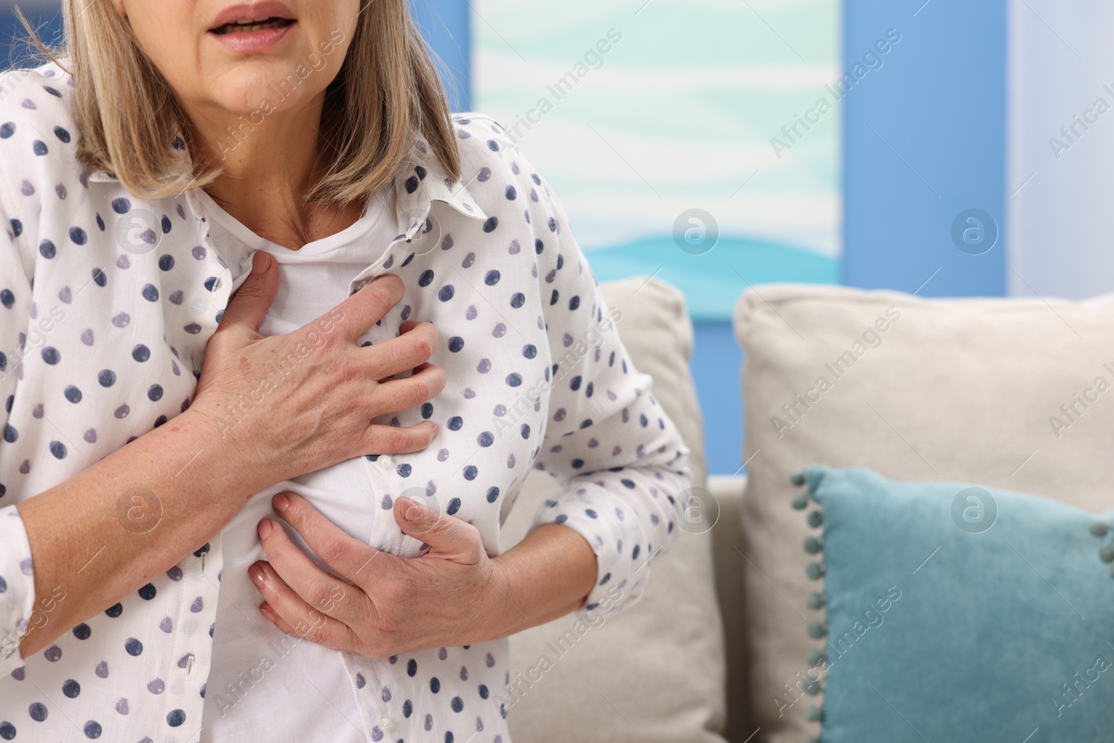 Photo of Heart attack. Senior woman suffering from pain in chest indoors, closeup. Space for text