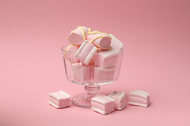 Photo of Tasty marshmallows in glass dessert bowl on pink background