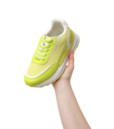 Photo of Woman with neon lime sneaker on white background, closeup