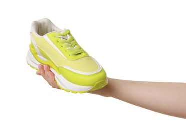 Photo of Woman with neon lime sneaker on white background, closeup