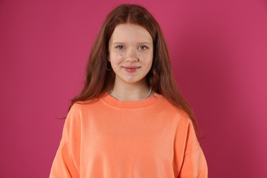 Photo of Beautiful teenage girl with freckles on pink background