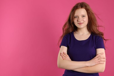 Photo of Beautiful teenage girl with freckles on pink background, space for text