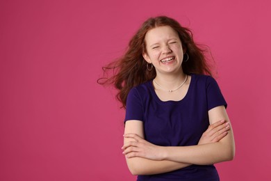 Photo of Beautiful teenage girl with freckles on pink background, space for text