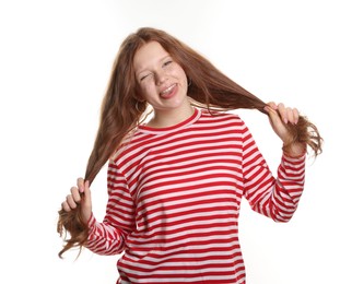 Photo of Beautiful teenage girl with freckles winking and showing her tongue on white background