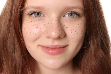 Photo of Beautiful teenage girl with freckles on white background, closeup