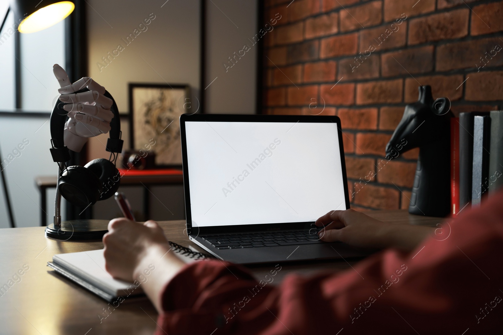 Photo of Woman working with laptop at table in office, closeup