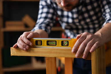 Photo of Repairman checking stool level in workshop, closeup