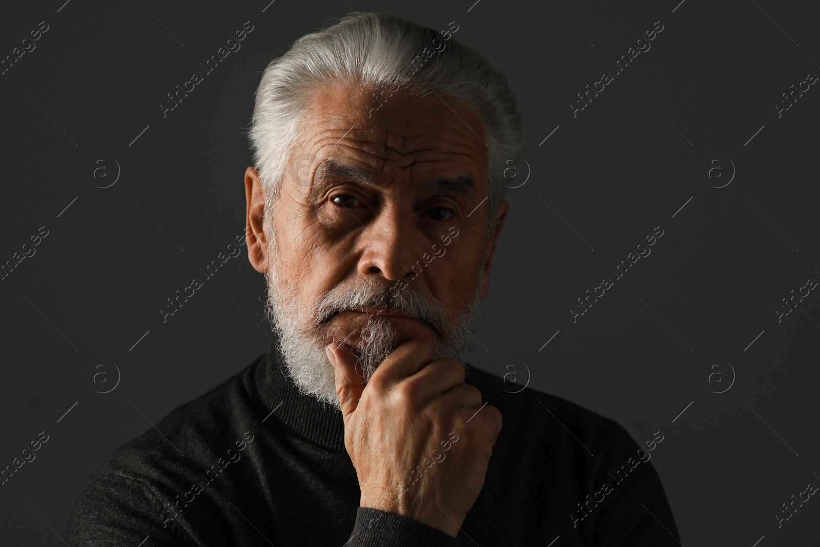 Photo of Portrait of bearded senior man on grey background