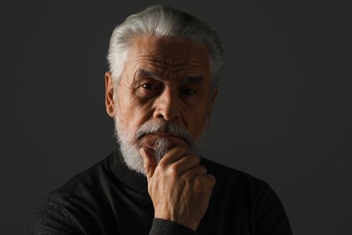 Photo of Portrait of bearded senior man on grey background