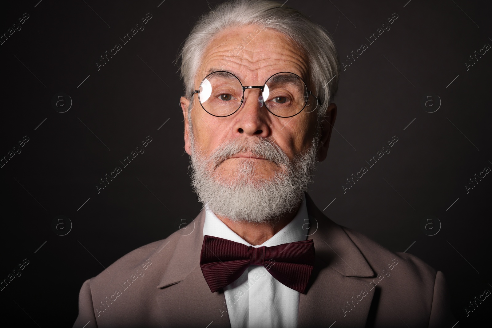 Photo of Portrait of handsome bearded man on black background