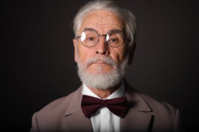 Photo of Portrait of handsome bearded man on black background