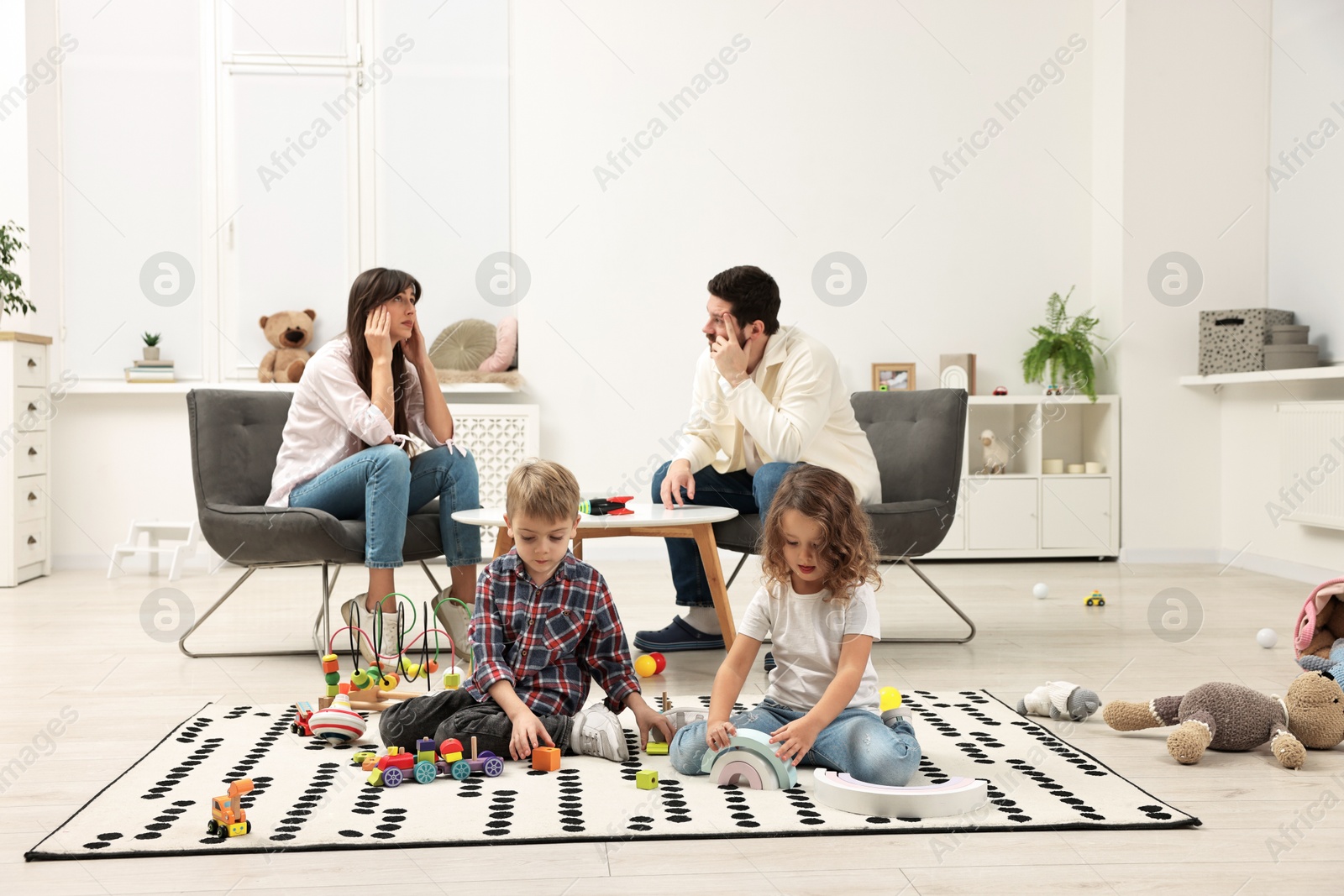 Photo of Hyperactive children playing and their overwhelmed parents at home