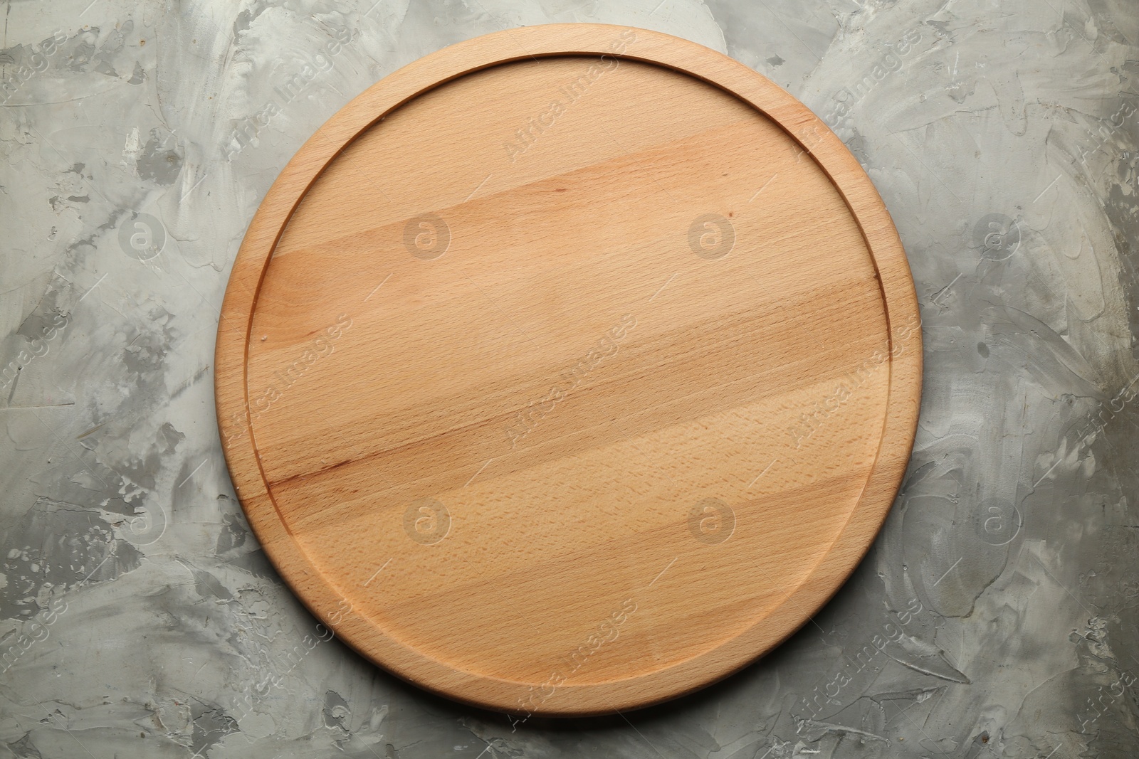 Photo of Wooden board on grey textured table, top view