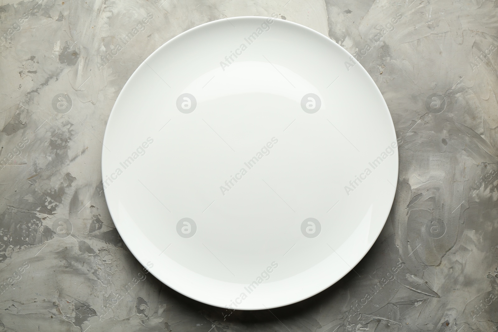 Photo of Stylish plate on grey textured table, top view