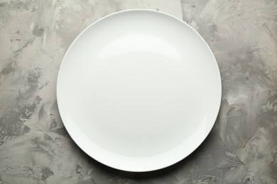 Photo of Stylish plate on grey textured table, top view