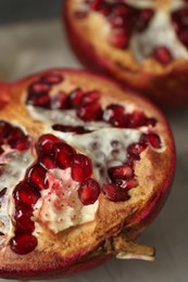 Photo of Fresh juicy pomegranates on grey table, closeup