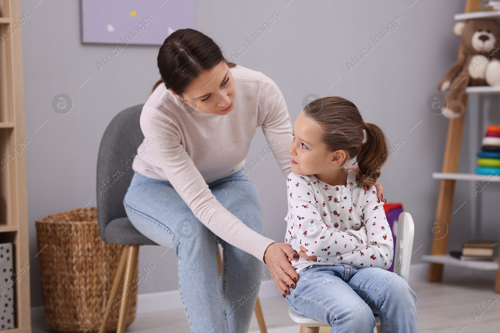 Photo of Resentful little girl and her mother arguing at home